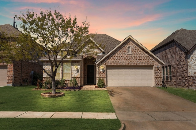 5604 Datewood Ln, Mckinney, TX 75071 - view of front of home featuring an attached garage, concrete driveway, brick siding, a front yard, and roof with shingles