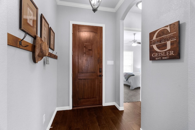 5604 Datewood Ln, Mckinney, TX 75071 - entryway with arched walkways, dark wood-style floors, baseboards, ornamental molding, and ceiling fan