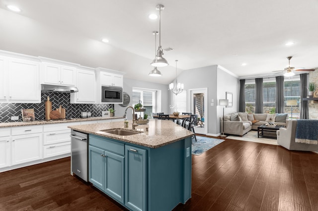 5604 Datewood Ln, Mckinney, TX 75071 - kitchen with a sink, appliances with stainless steel finishes, white cabinets, open floor plan, and lofted ceiling