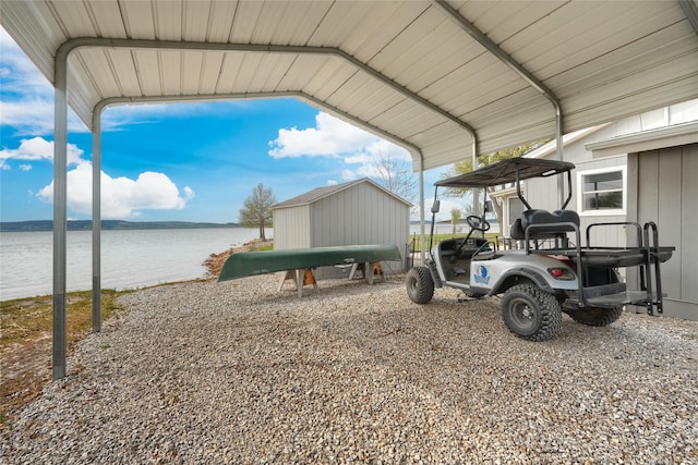 exterior space with a water view and a detached carport