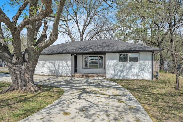 600 N Mill St, Bowie, TX 76230 - view of front of property featuring driveway, brick siding, and roof with shingles
