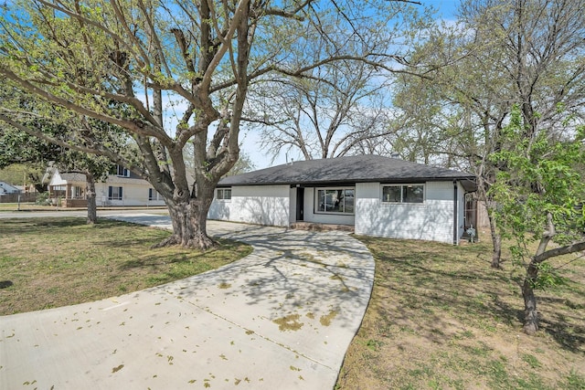600 N Mill St, Bowie, TX 76230 - view of front of house with concrete driveway, a front yard, and brick siding