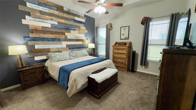 bedroom featuring baseboards and dark carpet