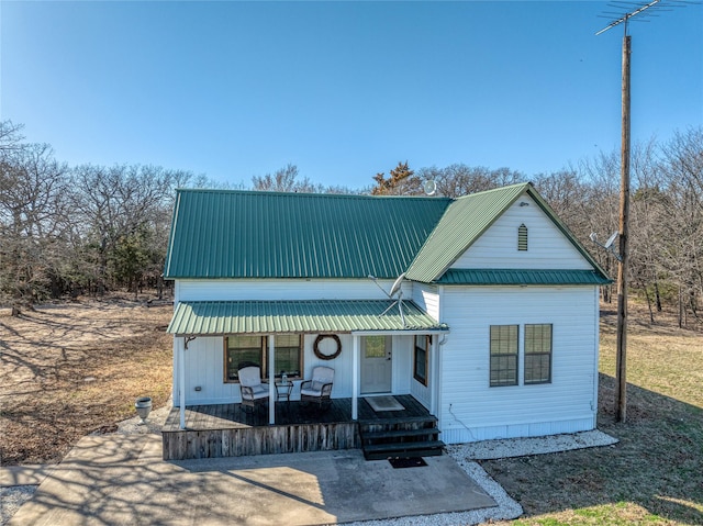 view of front of property featuring a porch and metal roof
