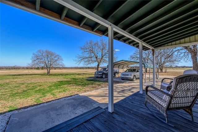 wooden terrace with a carport and a lawn