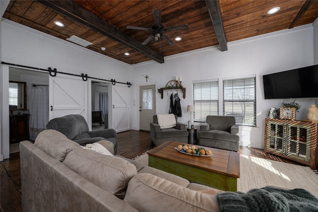 living area with wooden ceiling, beam ceiling, a ceiling fan, a barn door, and wood finished floors