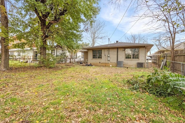 736 W Bullock Dr, Denison, TX 75020 - back of property featuring central AC and brick siding
