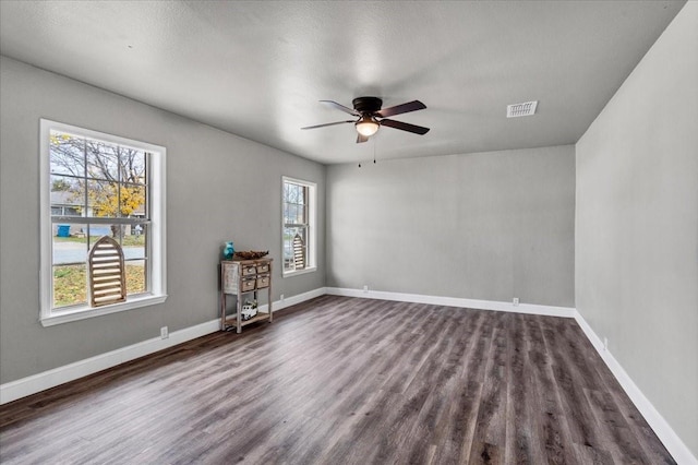 736 W Bullock Dr, Denison, TX 75020 - unfurnished room featuring dark wood-type flooring, ceiling fan, and baseboards
