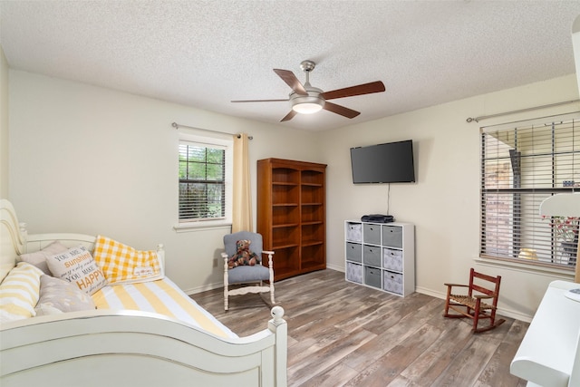 1 Cedar Bend Trl, Lucas, TX 75002 - bedroom with a textured ceiling, wood finished floors, baseboards, and a ceiling fan