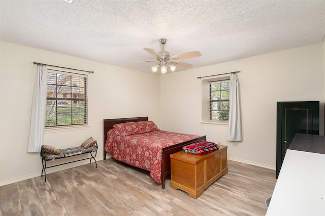 1 Cedar Bend Trl, Lucas, TX 75002 - bedroom with light wood finished floors, a textured ceiling, a ceiling fan, and baseboards