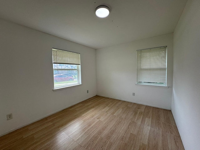 unfurnished room with wood finished floors