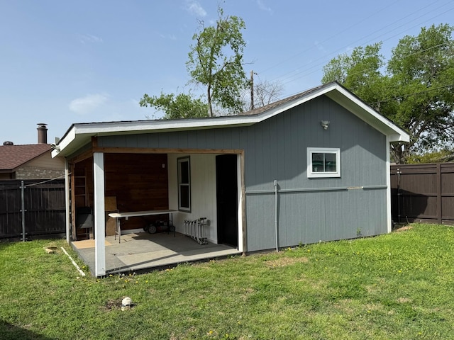 rear view of house with a patio, fence, and a yard