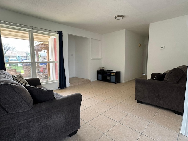 living room featuring light tile patterned floors and a textured ceiling
