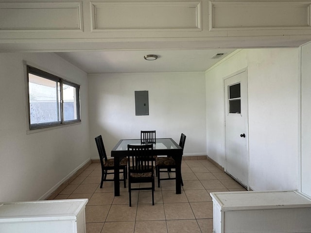 dining room featuring light tile patterned floors, visible vents, baseboards, and electric panel