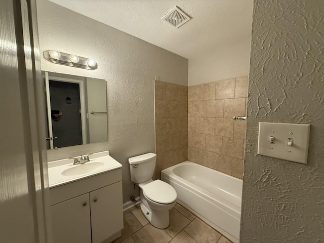 132 London Ln, Glenn Heights, TX 75154 - bathroom with a textured wall, toilet, vanity, tile patterned floors, and a textured ceiling