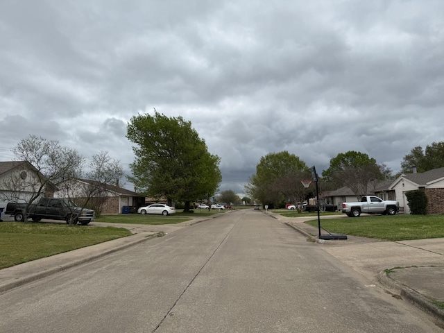 132 London Ln, Glenn Heights, TX 75154 - view of concrete street featuring curbs and sidewalks