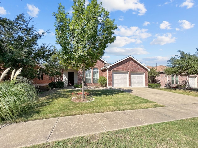 view of front of house with a front yard, an attached garage, brick siding, and driveway