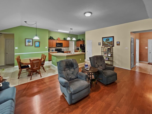 living area featuring light tile patterned floors and vaulted ceiling