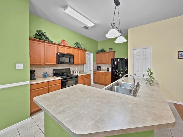 kitchen with a large island, light tile patterned floors, black appliances, and a sink