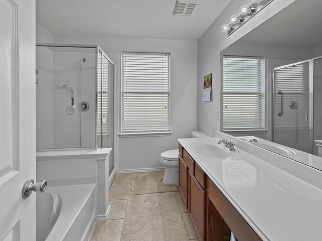full bathroom with a shower stall, a wealth of natural light, vanity, and visible vents