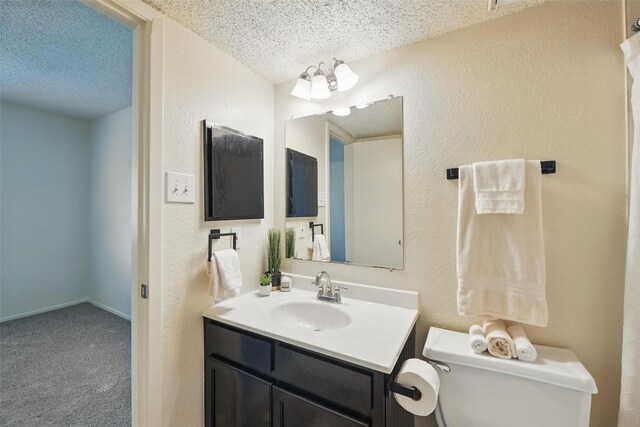 5912 Oregon Trl Ct, Haltom City, TX 76148 - bathroom with toilet, vanity, a textured wall, and a textured ceiling