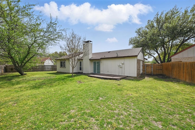 5912 Oregon Trl Ct, Haltom City, TX 76148 - rear view of property with a fenced backyard, a chimney, a deck, and a lawn