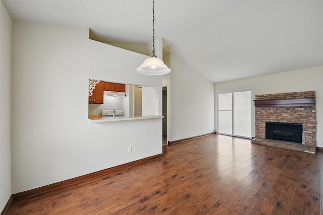 5912 Oregon Trl Ct, Haltom City, TX 76148 - unfurnished living room featuring baseboards, a fireplace, vaulted ceiling, and dark wood finished floors