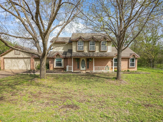 traditional home with brick siding, a garage, a front yard, covered porch, and driveway