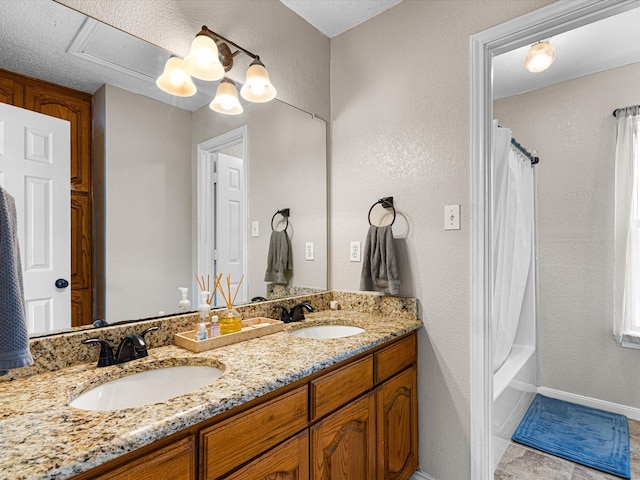 bathroom with a sink, a textured wall, double vanity, and shower / bath combination with curtain