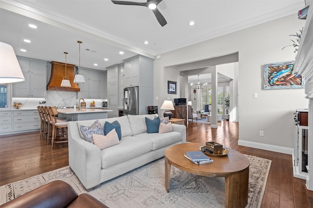 7501 Kickapoo Dr, Mckinney, TX 75070 - living area featuring visible vents, crown molding, wood finished floors, a glass covered fireplace, and recessed lighting