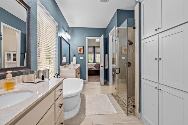 7501 Kickapoo Dr, Mckinney, TX 75070 - full bath with visible vents, a freestanding tub, two vanities, a shower stall, and a sink