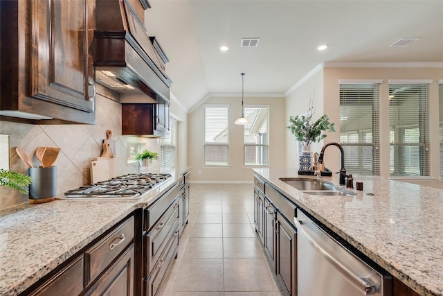 9836 Arctic Dr, Frisco, TX 75035 - kitchen with a sink, stainless steel appliances, custom range hood, baseboards, and ornamental molding