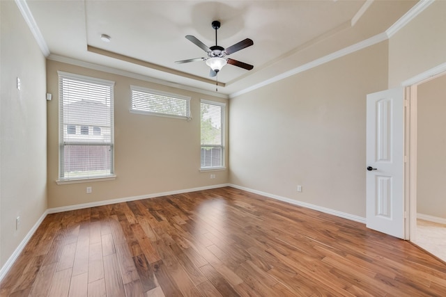 9836 Arctic Dr, Frisco, TX 75035 - empty room featuring a raised ceiling, light wood-type flooring, ceiling fan, crown molding, and baseboards