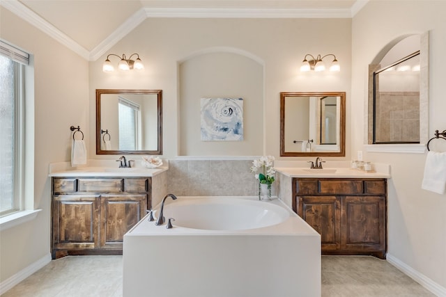 9836 Arctic Dr, Frisco, TX 75035 - full bathroom featuring a bath, two vanities, ornamental molding, lofted ceiling, and baseboards