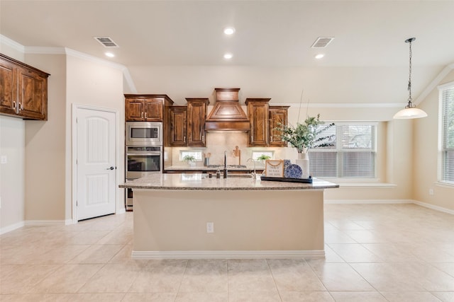 9836 Arctic Dr, Frisco, TX 75035 - kitchen featuring appliances with stainless steel finishes, light stone countertops, a sink, custom range hood, and recessed lighting