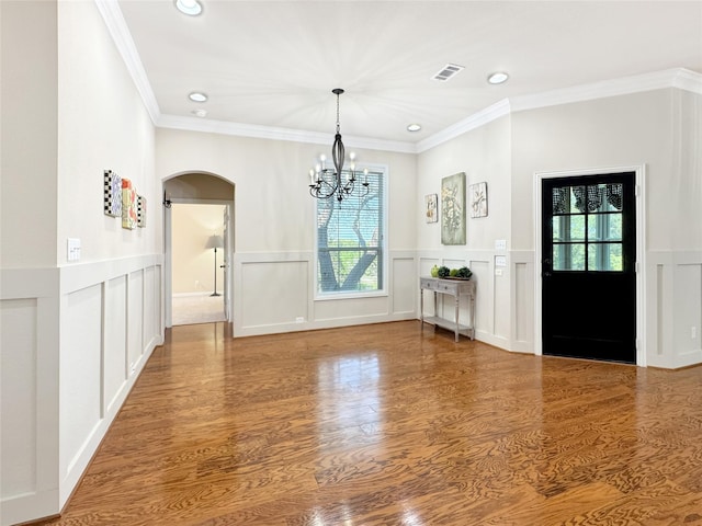 interior space featuring recessed lighting, visible vents, arched walkways, a decorative wall, and a notable chandelier