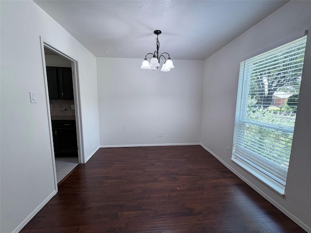 941 Overdowns Dr, Plano, TX 75023 - unfurnished room with a chandelier and wood finished floors