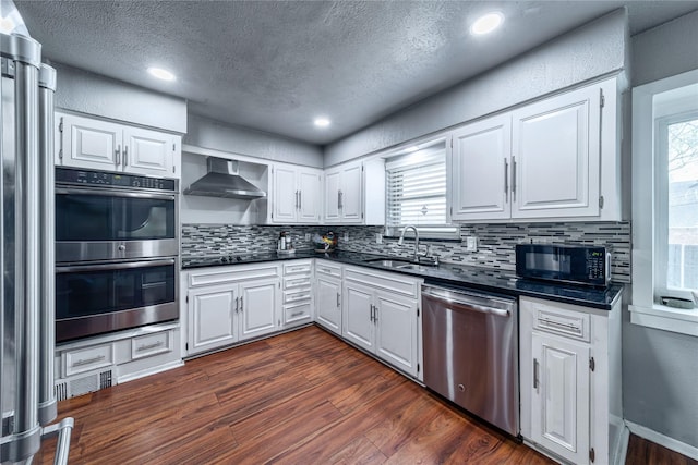 6110 Caracas Dr, Dallas, TX 75232 - kitchen featuring a sink, wall chimney exhaust hood, dark countertops, black appliances, and dark wood-style flooring