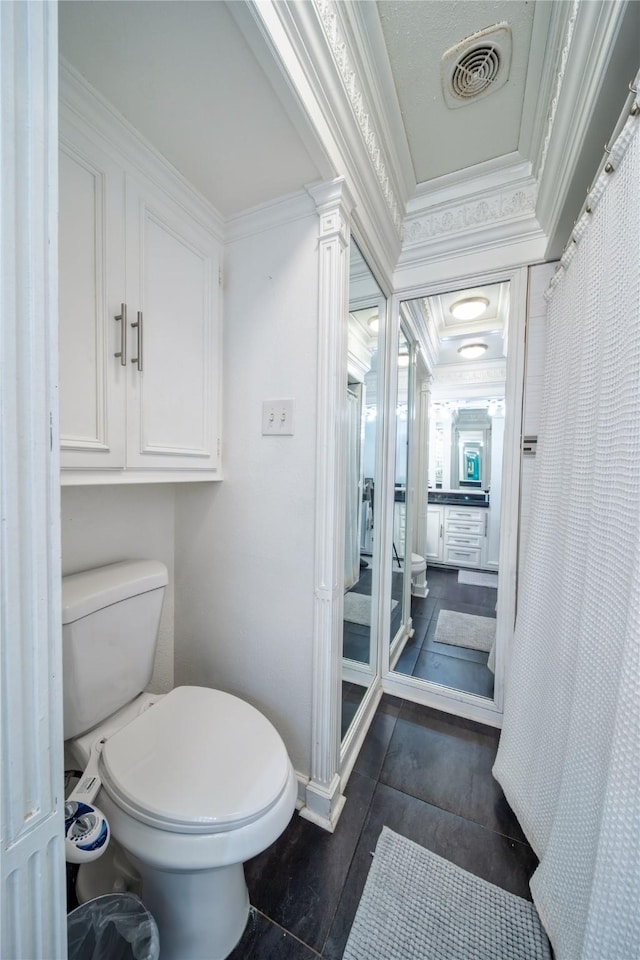 6110 Caracas Dr, Dallas, TX 75232 - bathroom featuring decorative columns, toilet, ornamental molding, baseboards, and visible vents