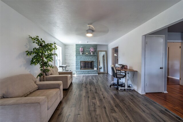 6110 Caracas Dr, Dallas, TX 75232 - living area featuring baseboards, wood finished floors, a ceiling fan, and a brick fireplace