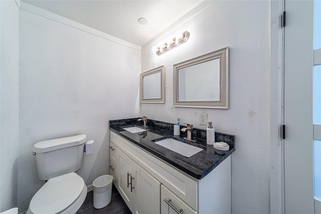 6110 Caracas Dr, Dallas, TX 75232 - full bathroom with a textured wall, double vanity, a sink, and toilet