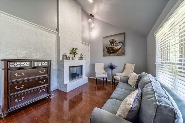 6110 Caracas Dr, Dallas, TX 75232 - living room featuring dark wood finished floors, baseboards, high vaulted ceiling, and a brick fireplace