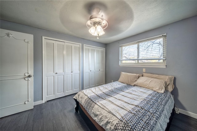 6110 Caracas Dr, Dallas, TX 75232 - bedroom with dark wood finished floors, baseboards, multiple closets, and a textured ceiling