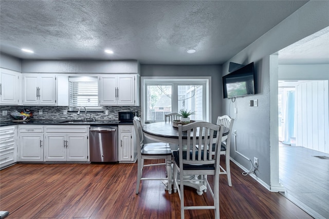 6110 Caracas Dr, Dallas, TX 75232 - kitchen featuring dishwasher, a sink, dark countertops, and dark wood-style floors