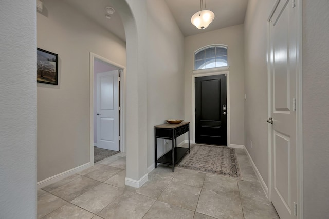 560 Camber St, Saginaw, TX 76131 - foyer featuring light tile patterned floors, baseboards, and arched walkways