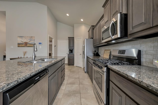 560 Camber St, Saginaw, TX 76131 - kitchen with a sink, decorative backsplash, dark stone countertops, and stainless steel appliances