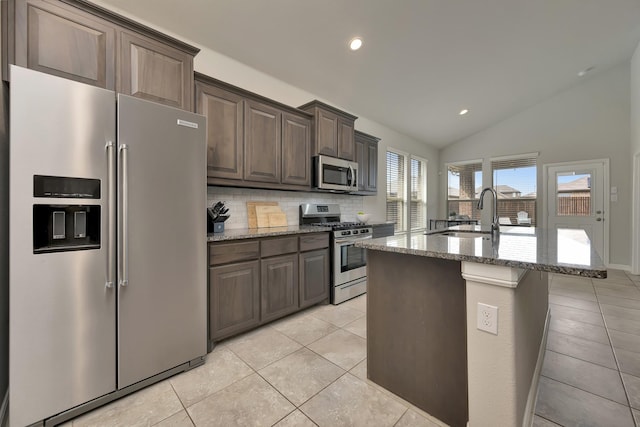 560 Camber St, Saginaw, TX 76131 - kitchen featuring light stone counters, light tile patterned floors, backsplash, stainless steel appliances, and a sink