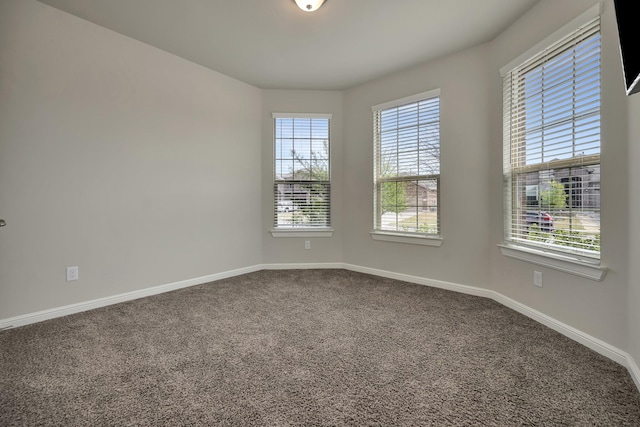 560 Camber St, Saginaw, TX 76131 - empty room featuring plenty of natural light, baseboards, and dark carpet