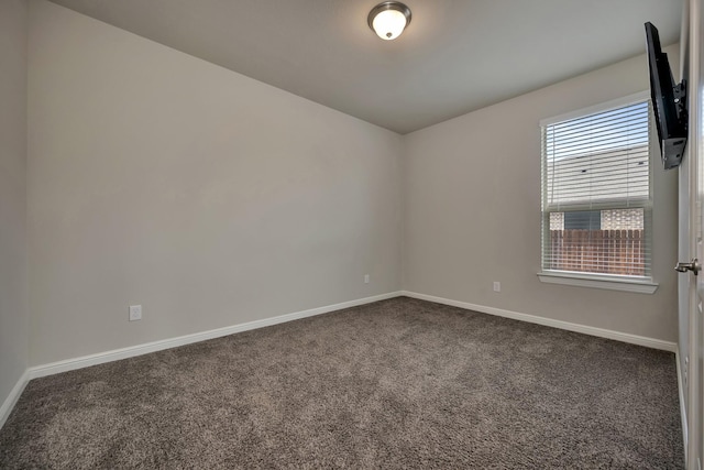 560 Camber St, Saginaw, TX 76131 - empty room featuring baseboards and dark colored carpet