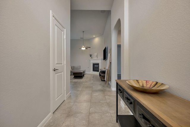 560 Camber St, Saginaw, TX 76131 - hallway featuring arched walkways, baseboards, and light tile patterned flooring